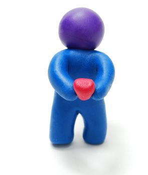 Standing Blue Plasticine Man Holding Red Heart Isolated on White Background with Shadow