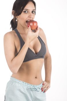 A sexy young hispanic woman wearing a gym outfit, isolated on a white background.