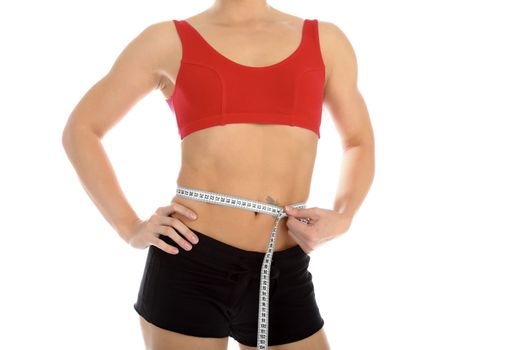 Sporty woman with a measuring tape round the waist, isolated over white background