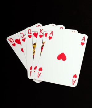 A royal straight flush playing cards poker hand in hearts