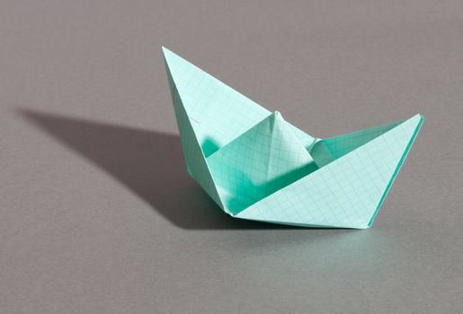 Paper ship, photo on the grey background