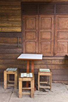 Wooden tables and chairs near the old window