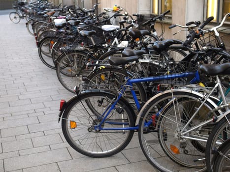 Row of bikes or bicycles parked - selective focus, copy space