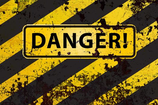 "Danger" on the grunge yellow-black striped  background 