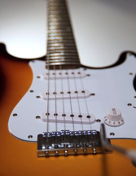 Closeup of strings and pickups of an electric guitar