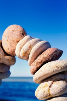 Curved in form of arc a set of the pebble of the against the sky