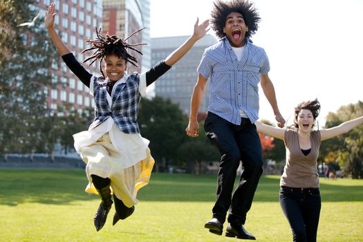 A group of people jumping for joy in a city park