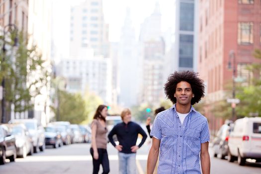 A city setting with a group of friends, a happy African American in the foreground