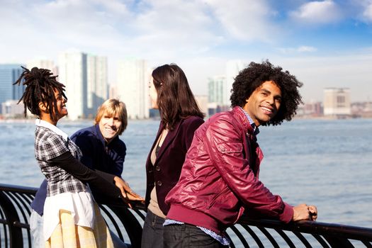 A group of friends in the city - overlooking a harbor and skyline