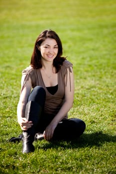 A pretty female isolated on a background of grass in a park