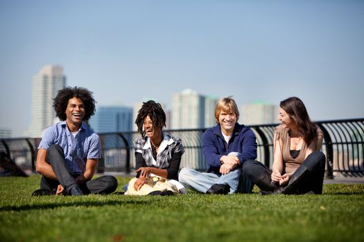 A group of friends in a city park talking and laughing