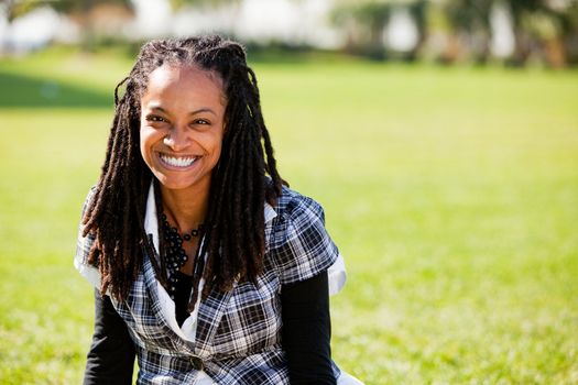 A beautiful African American woman isolated on grass