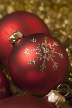 Red christmas ball on the gold tinsel. aRGB.