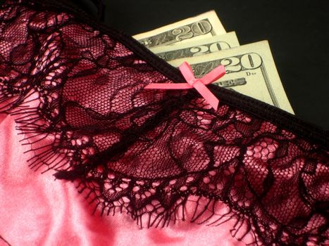 Photos of business and pleasure, lingerie mixed with money