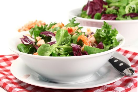 mixed, colorful salad with crayfish on a white background