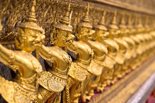 The wall with statues of golden garuda, Wat Phra Keo, Bangkok, Thailand