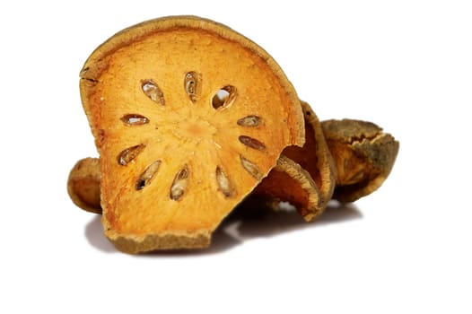 Bale Fruit dried tee. Isolated on white. Bale fruit is tropical fruit with hard exterior cover. The fruit has medicinal value for digestive system. Extensively consumed in rural India and Thailand.