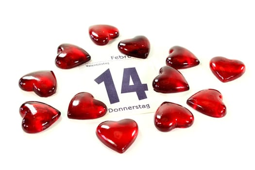 a calendar page with small red hearts