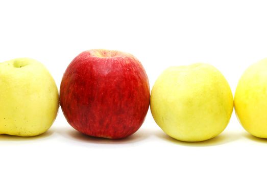 Red Leader Apple between Yellow Apples in Row Isolated on White Background