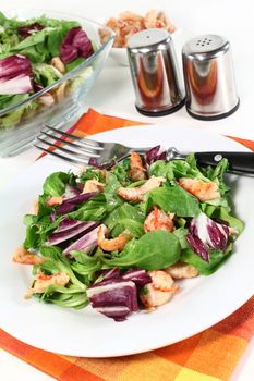 mixed, colorful salad with crayfish on a white background