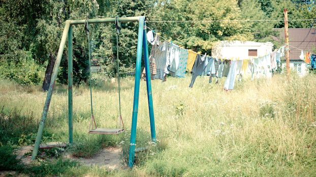 Drying clothes on the rope and empty swing