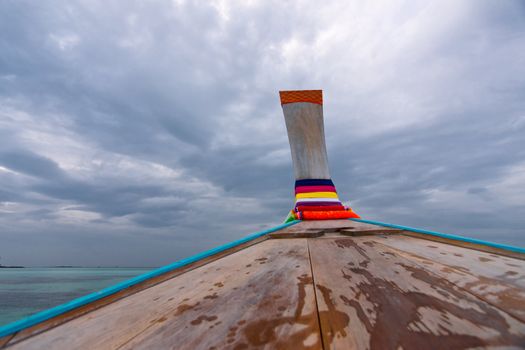 Nose of wooden boat decorated with ribbons