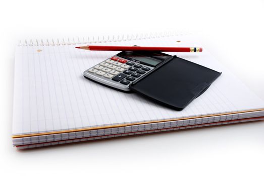 Pictures of a calculator and glasses resting on a notepad, ready to do calculations