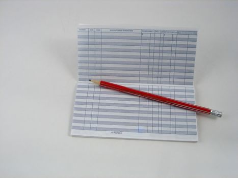 Checkbook, notepad and calculator used to make financial decissions