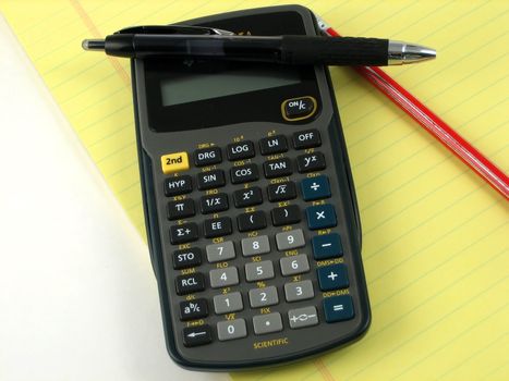 Checkbook, notepad and calculator used to make financial decissions