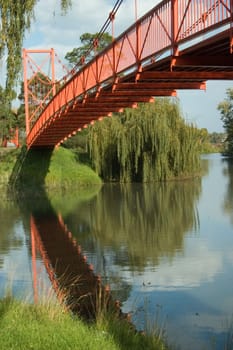 A Colourful Scenic Red Bridge over a River Photo