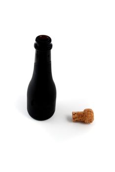 Pictures of an empty bottle of champagne with the cork at it side