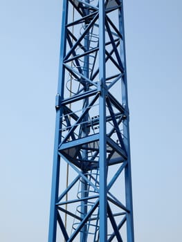 Detail of a tower crane over blue sky