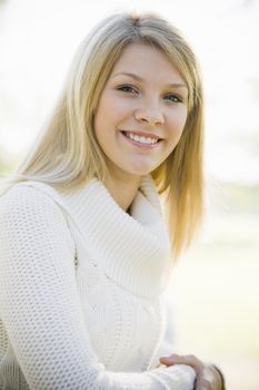 Portrait of a Pretty Blond Teen Girl Standing in a Park