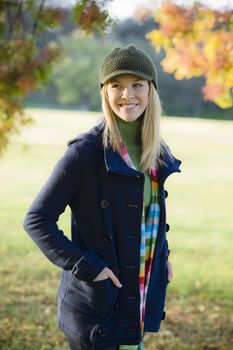 Portrait of a Pretty Blond Teen Girl Standing in a Park