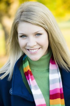 Portrait of a Pretty Blond Teen Girl Standing in a Park