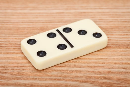 One tile dominoes lying on a wooden surface close up