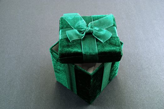 Green gift box with a laced up bow