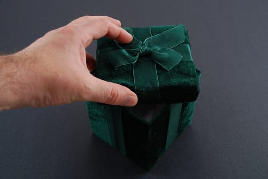 Green gift box with a laced up bow