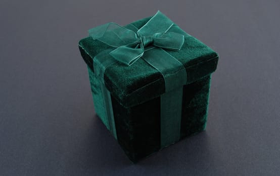 Green gift box with a laced up bow