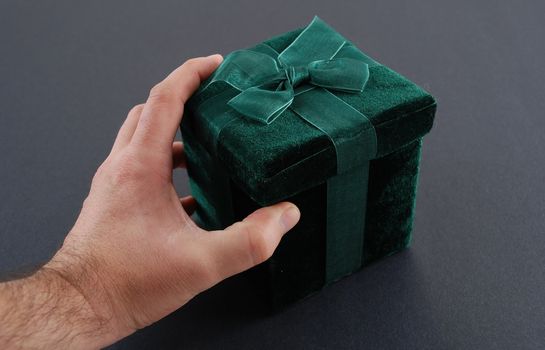 Green gift box with a laced up bow