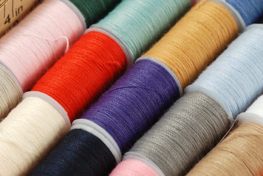 colorful spools of multi colored threads for sewing and knitting