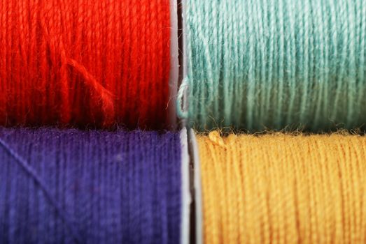 colorful spools of multi colored threads for sewing and knitting