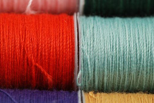 colorful spools of multi colored threads for sewing and knitting