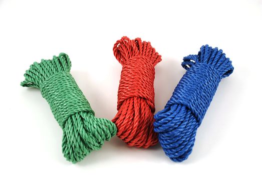 three coils of rope in green, blue and red