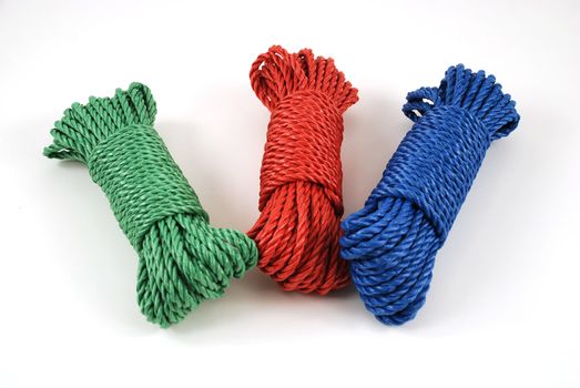 three coils of rope in green, blue and red