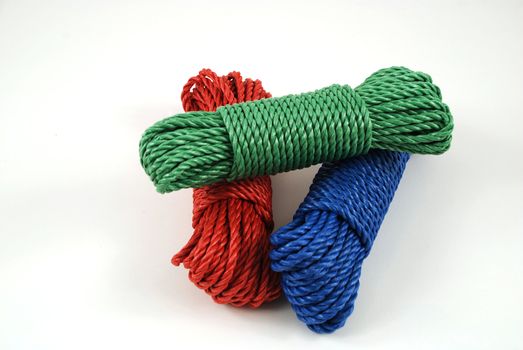 three coils of rope in green, blue and red