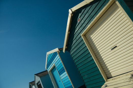 A Colorful Warm Photo of a Row of Beach Huts