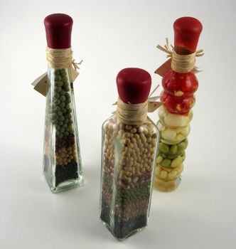 Bottles with oil and legumes inside used for decorative purposes in kitchens