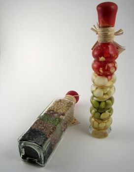 Bottles with oil and legumes inside used for decorative purposes in kitchens