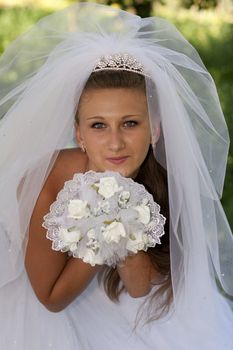 The bride with a bouquet of white flowers